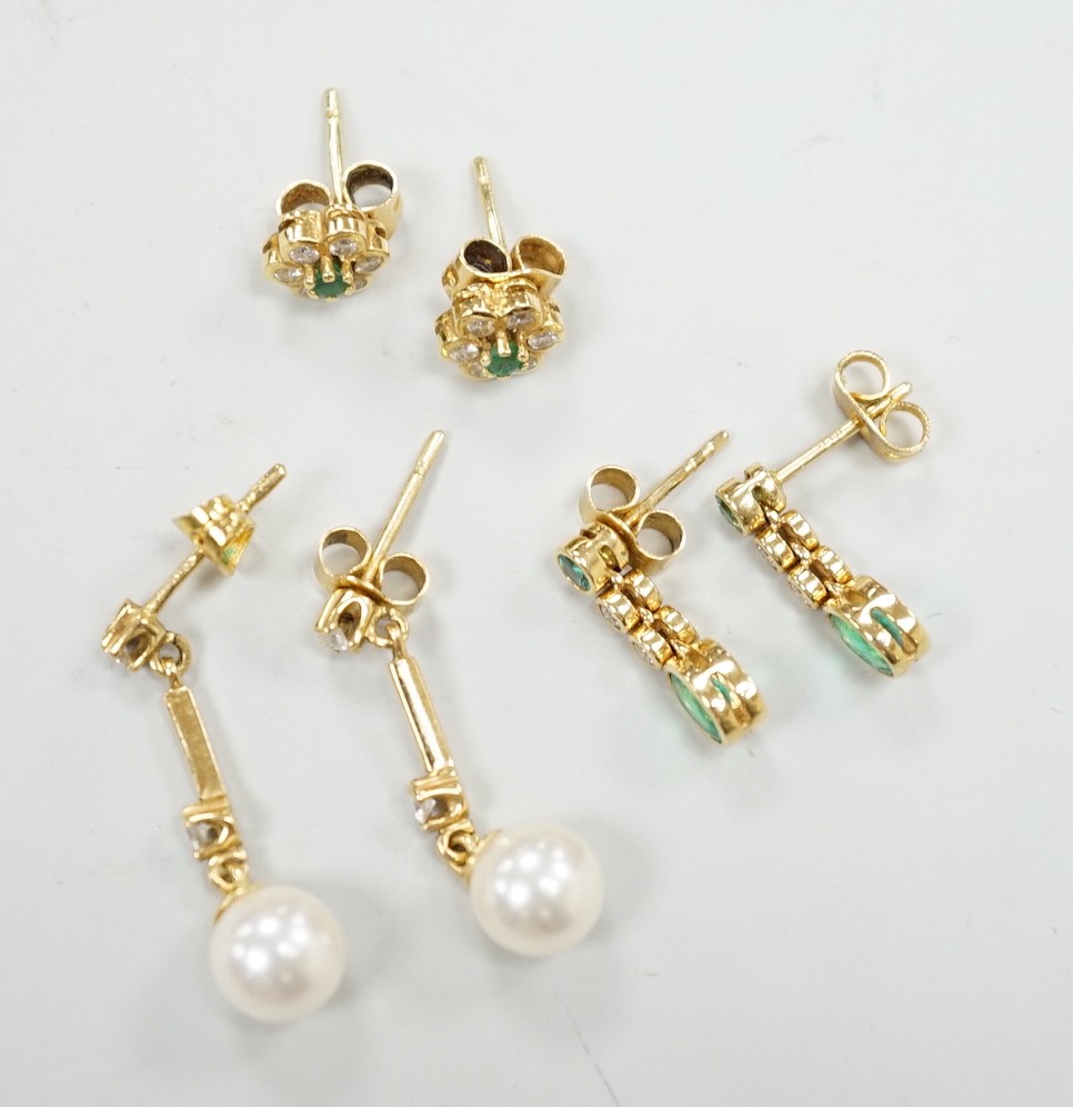 Two modern pairs of 18ct gold, emerald and diamond set ear studs and a pair of 18ct gold, cultured pearl and diamond set ear studs, gross weight 7 grams.